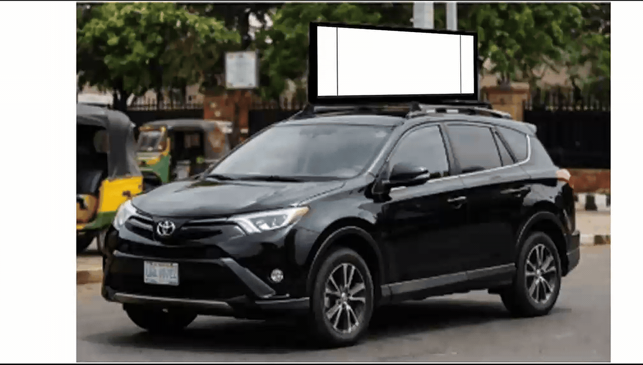 White sedan fitted with a rooftop digital advertising screen